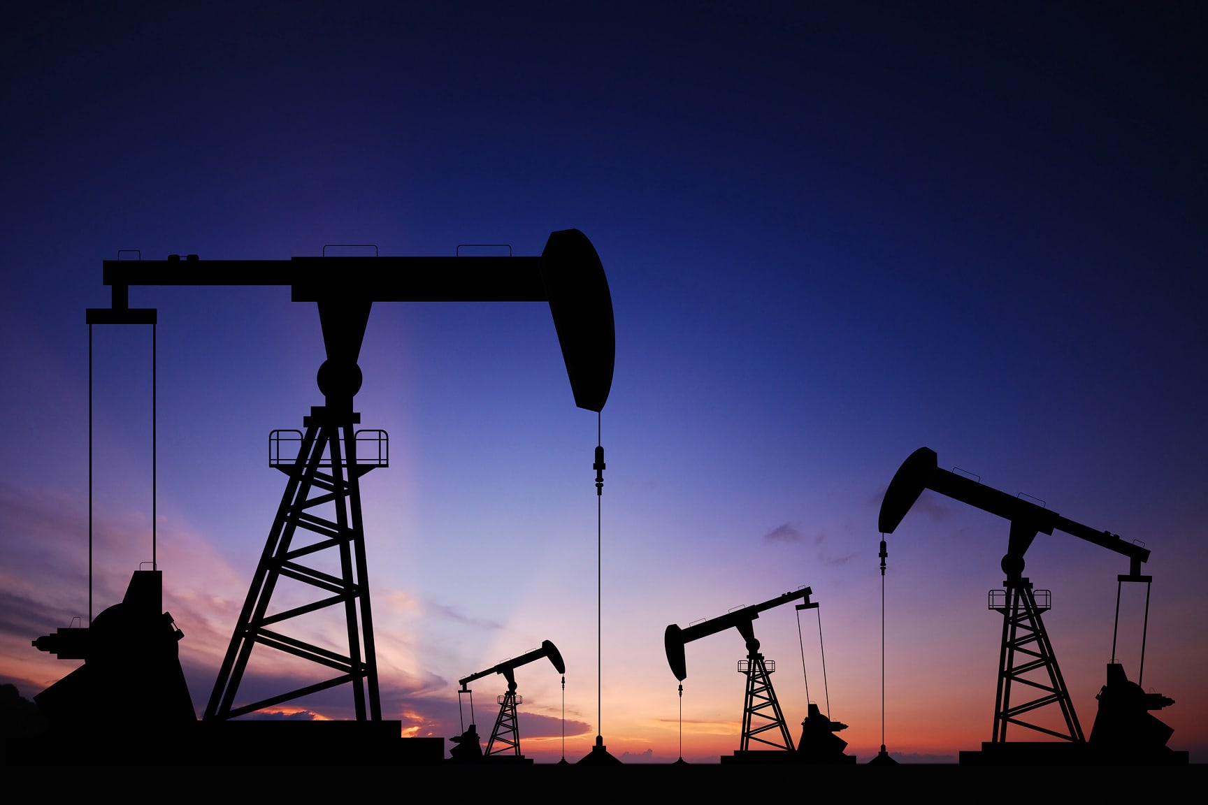 Images of pumpjacks pulling oil from the ground