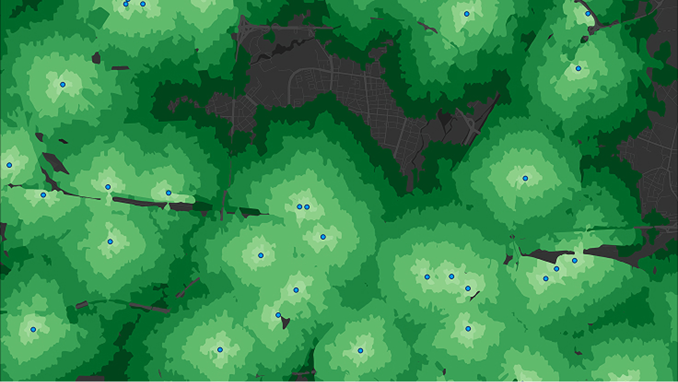 Map with pins surrounded by circles in a gradient of light green to dark green denoting market data.