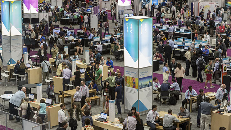 The show floor at the Esri User Conference, filled with booths and attendees
