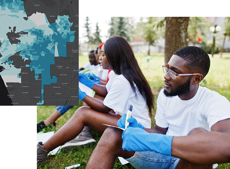 Young Black people sitting outdoors working on a community project