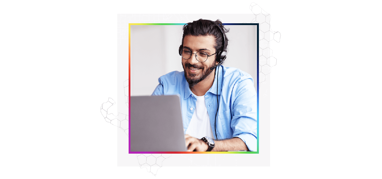 A technical support expert wearing a headset and working on their laptop to help a client