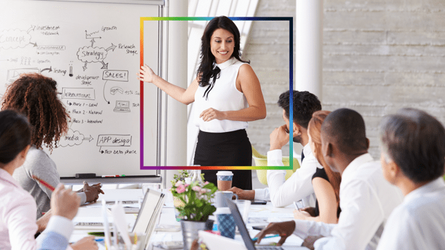 Beraterin, die Mitgliedern einer Organisation am Konferenztisch eine auf einem Whiteboard dargestellte Roadmap zeigt