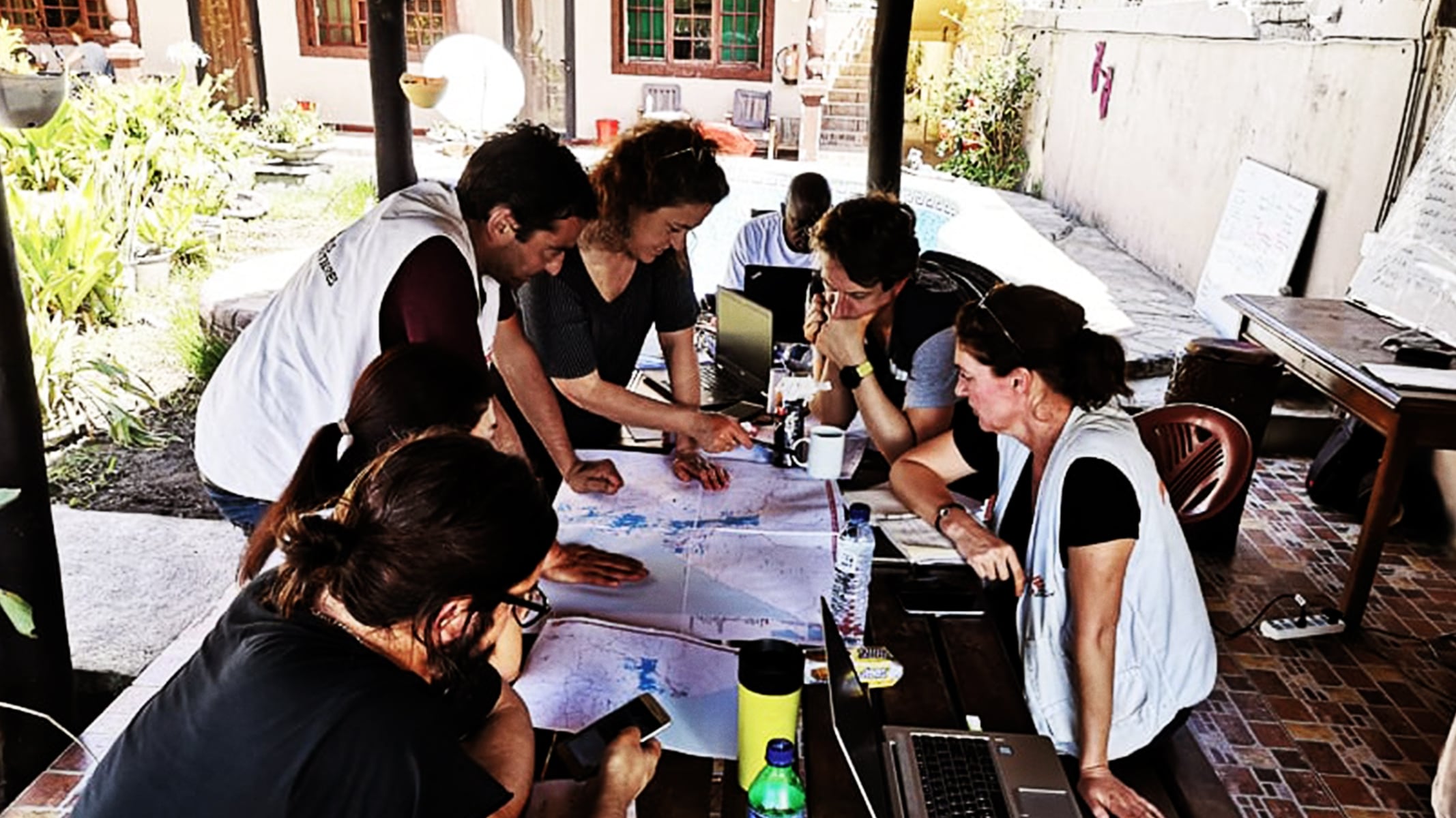 A GIS team with Doctors Without Borders collaborates over a map