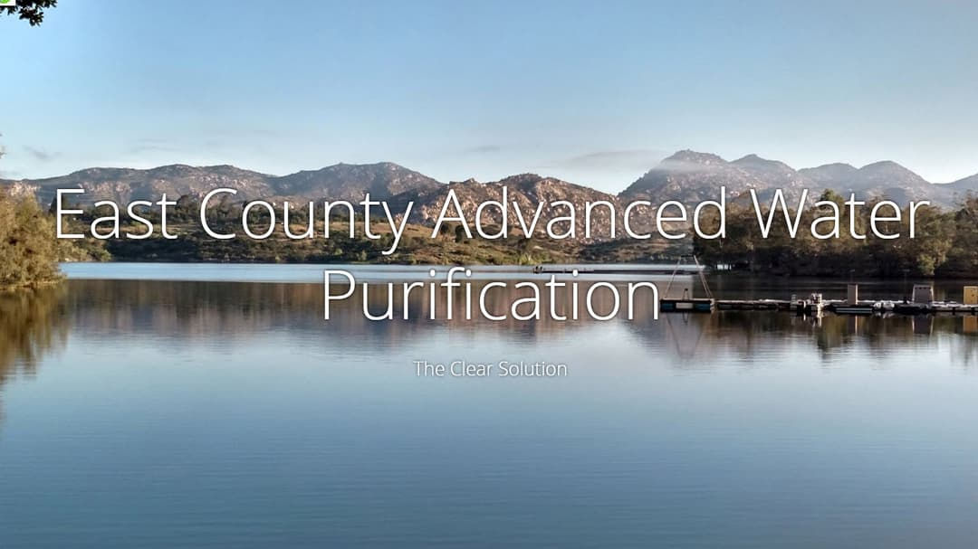 A serene lake surrounded by rolling hills is featured in this image, with text overlay reading 'East County Advanced Water Purification' and 'The Clear Solution.' 