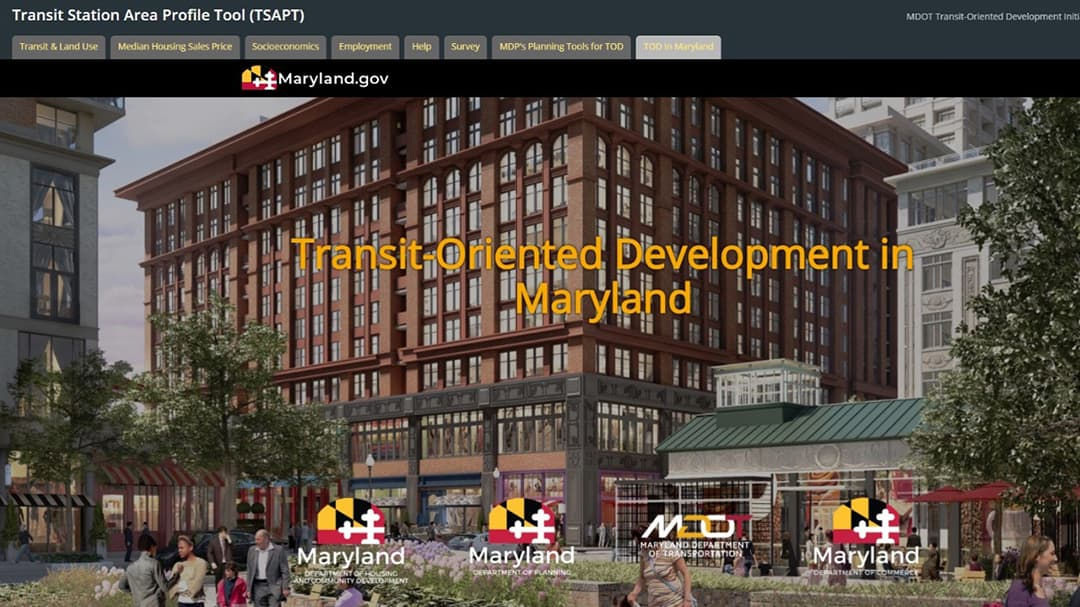 A vibrant urban scene showcasing a large brick building in Maryland, surrounded by trees and pedestrians.