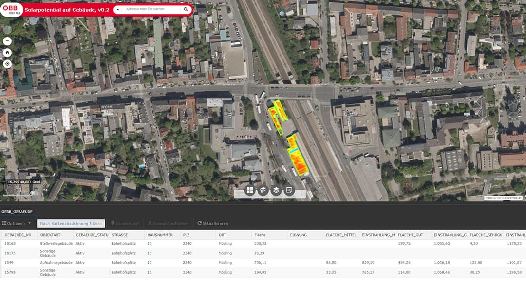 An aerial image showcasing a densely built urban area with roads, buildings, and green spaces.