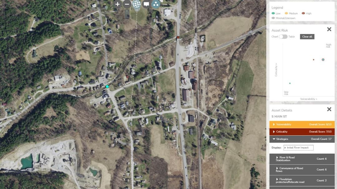An aerial image showcasing a small rural town with intersecting roads at the center. 