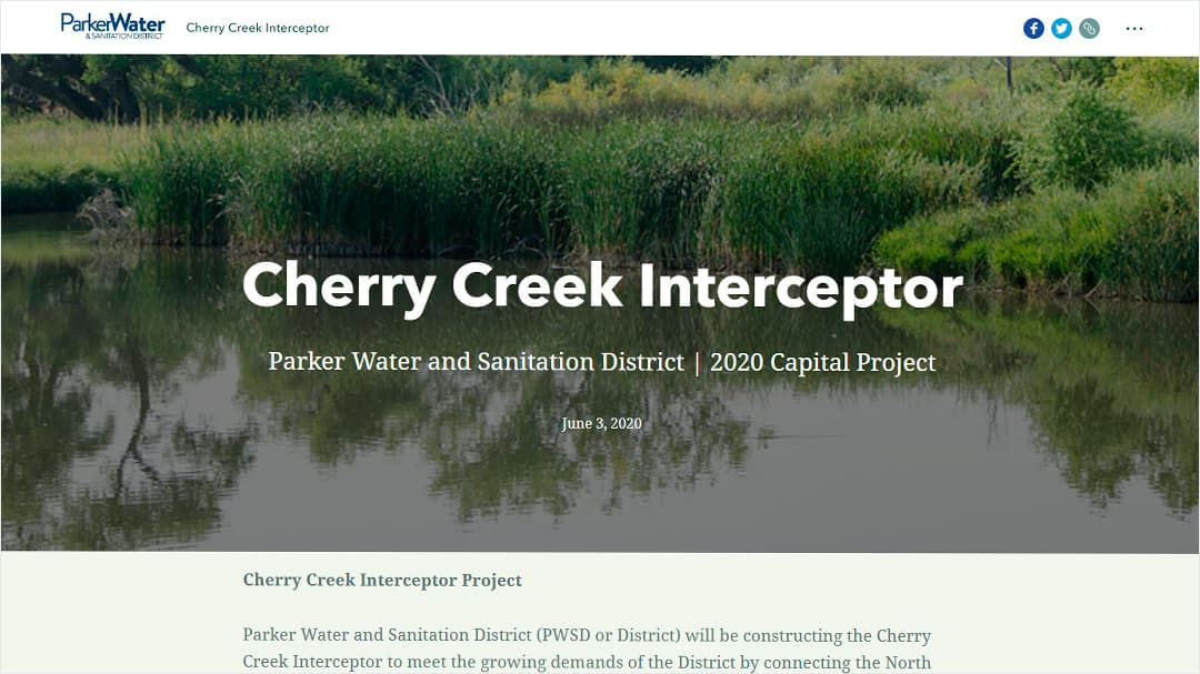 A serene view of Cherry Creek with lush greenery and calm waters.