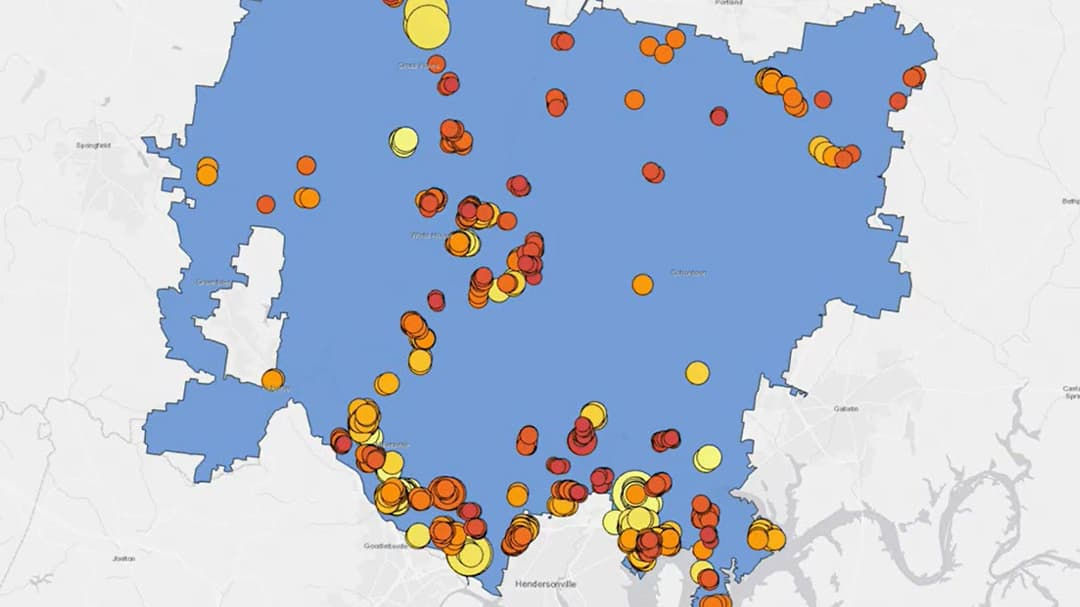 A detailed map showcasing a blue geographic region with clusters of data points represented by red, orange, and yellow circles. 