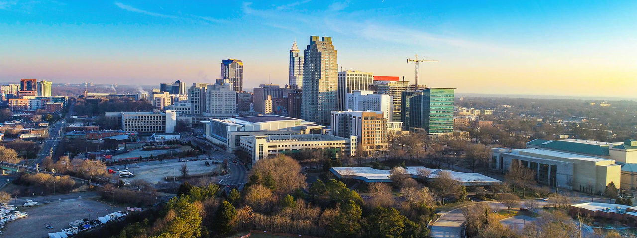 A vibrant aerial view of downtown Raleigh, showcasing modern skyscrapers and urban architecture. 