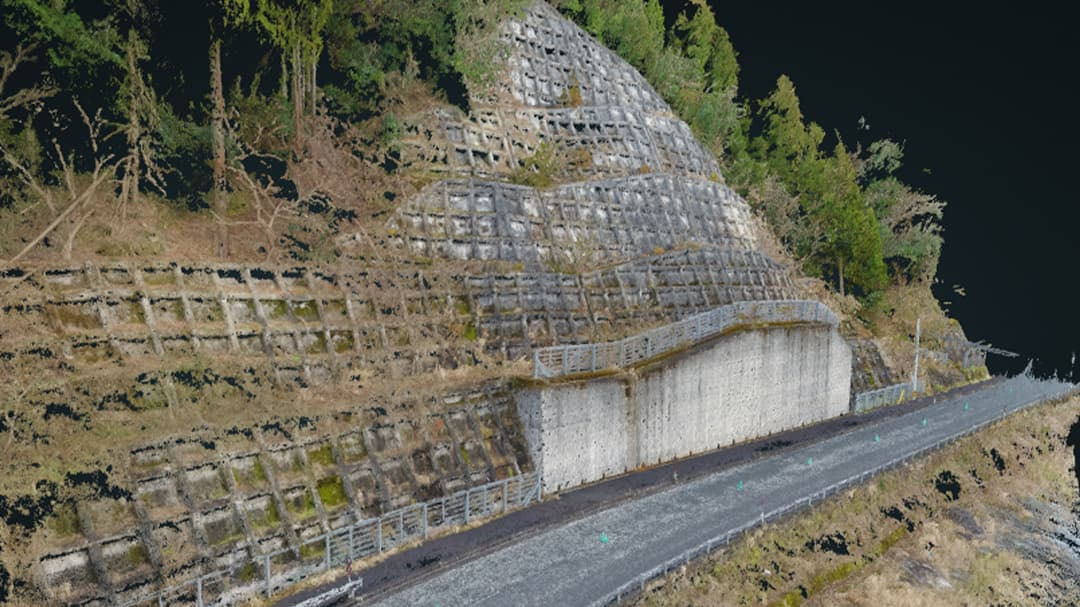 A steep hillside reinforced with a concrete grid structure to prevent erosion and landslides. 