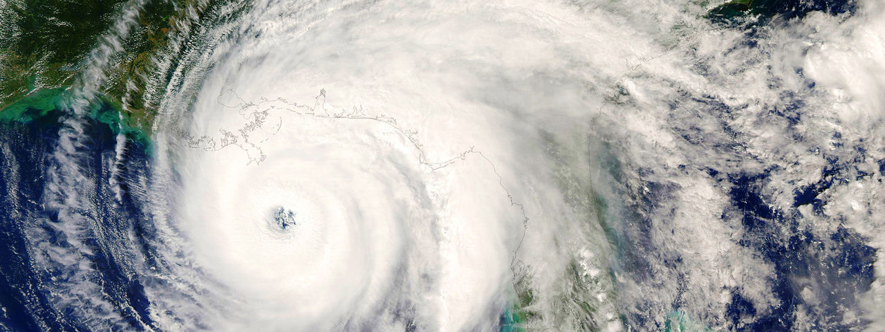 A swirling hurricane captured from a satellite perspective, showcasing its distinct eye and expansive cloud formations.
