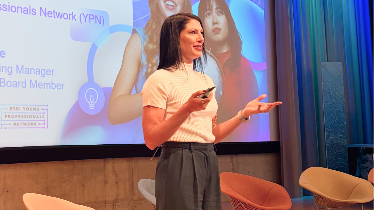 Esri’s Rosemary Boone presenting with a slide about the Esri Young Professionals Network in the background