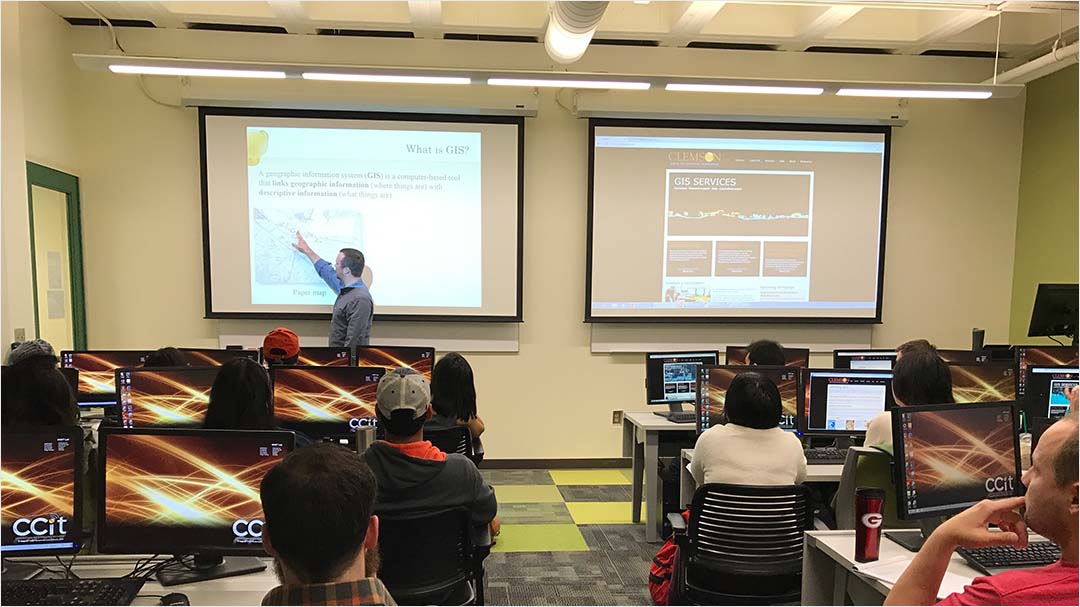 Instructor defines GIS in a presentation to a group of students