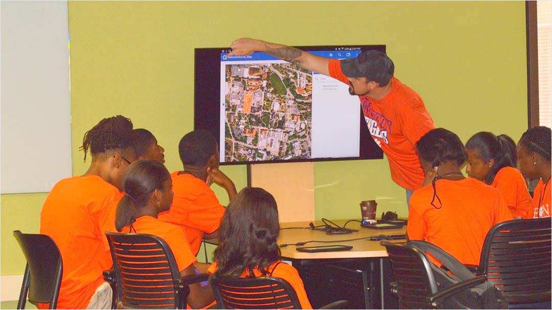 Intern leads classroom lesson for high school students in the GIS training lab