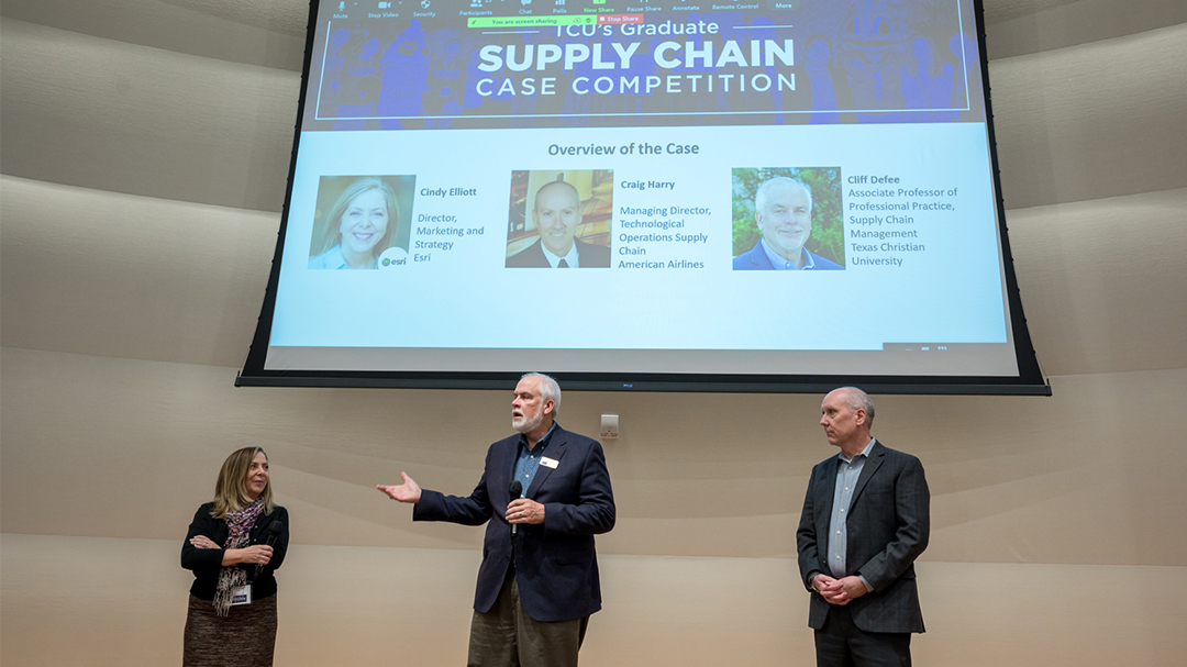 From left Cindy Elliot, Cliff Defee, and Craig Henry stand on stage opening the TCU Graduate Supply Chain competition