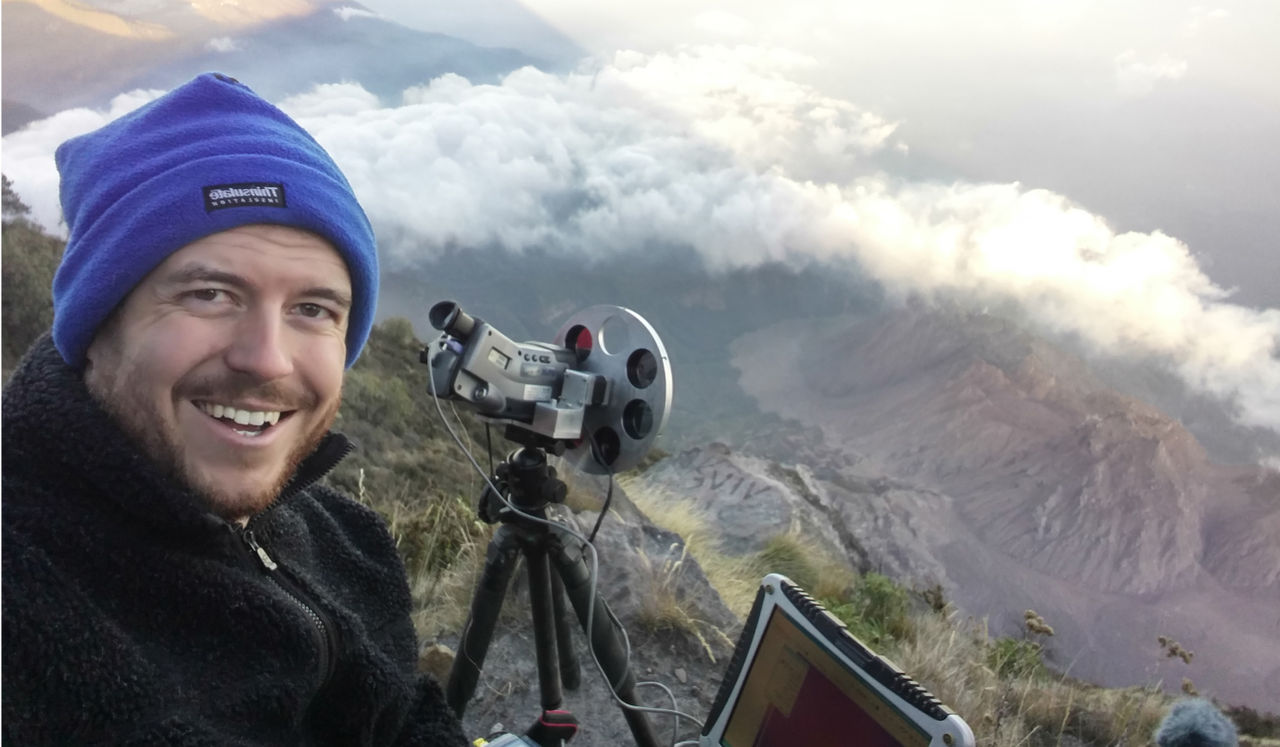 Professor Williams smiling while using a modified thermal camera to study Santiaguita Volcano in Guatemala from a high vantage point