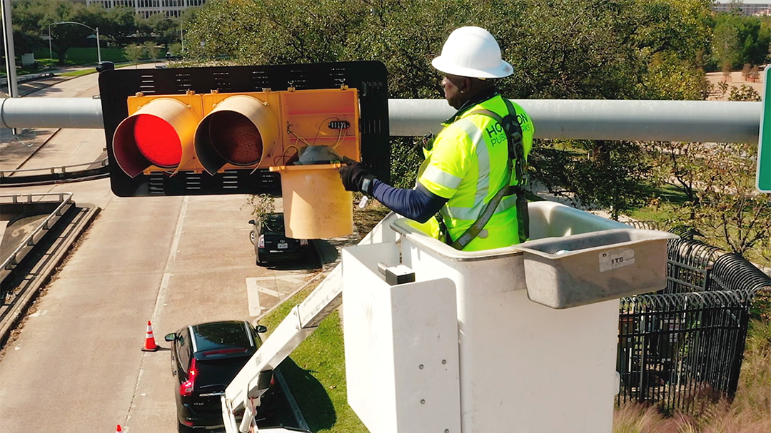 Houston Public Works traffic sign maintenance worker installing traffic lights