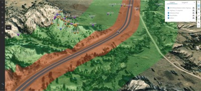 A birds-eye view map of a highway curving gently through hilly green terrain and various colored markers dot the landscape