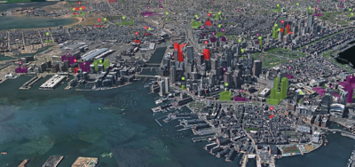 A 3D cityscape with clusters of buildings and roads along the water with scattered green and red data points
