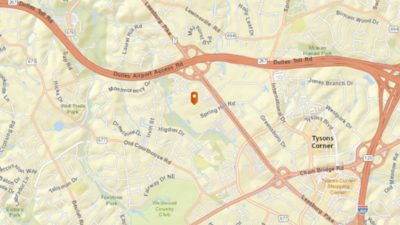 Beige map showing location pin on Spring Hill Road with street names in black text and several routes highlighted in peach