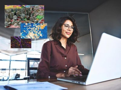 Femme portant des lunettes qui utilise un ordinateur portable pour analyser des données géographiques et relatives à une ville affichées à l’écran