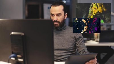 Homme assis à un bureau devant son ordinateur avec des encarts représentant des visualisations de données colorées et des cartes 