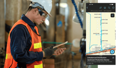 A field technician in a safety vest uses a tablet indoors, with a floor‑aware map interface displayed alongside the photo