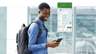 Smiling person wearing a backpack looking at their smartphone with an inset showing indoor navigation to Office OA-07.