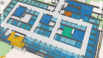 색상으로 구분된 영역과 대화형 내비게이션 패널이 표시된, 회색 벽의 건물 평면도를 비스듬한 각도에서 보여주는 3D 렌더링
