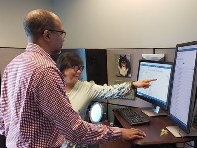 Anthony Powell and Jane Chen looking at ArcGIS Monitor metrics