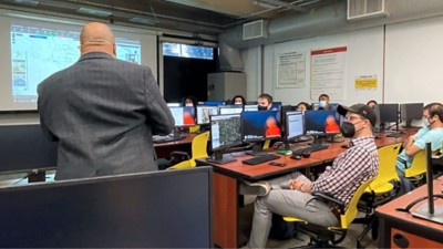Students with computers in front of them in a classroom