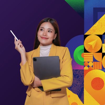 Smiling person with grey hair wearing a blue button up shirt