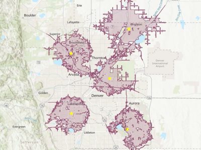 3D visualization of a cityscape featuriMap of the Denver metropolitan area showing multiple shaded purple polygon regions connected by corridor-like shapes modern block‑style buildings surrounded by dense clusters of trees