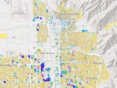 Map of the Salt Lake City area showing a detailed street grid overlaid with many small, color-coded parcels in yellow, blue, green, and purple.