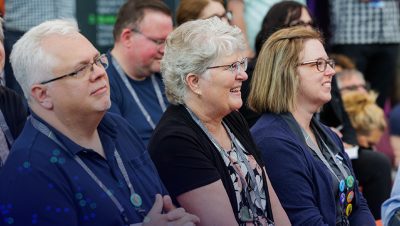 Side view of an audience listening intently to a presentation
