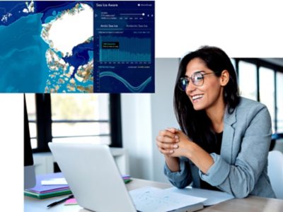 A person participating in a virtual meeting with sea ice maps and monitoring dashboards displayed nearby