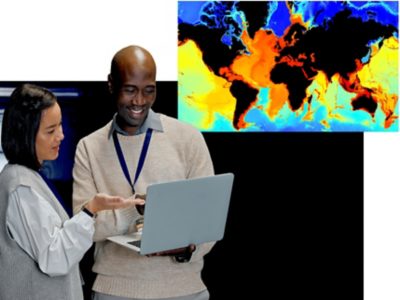 Two professionals reviewing geospatial data on a laptop with a global ocean temperature map in the background