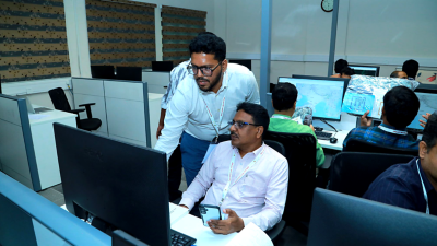 Interior photo of a modern high school with students climbing the stairs and walking through the hallways