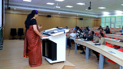 Interior photo of a modern high school with students climbing the stairs and walking through the hallways
