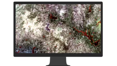 A computer monitor displaying aerial image of a highway overlaid with a web of bright colors suggesting frequently used routes