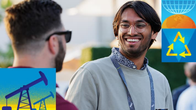Two attendees engaged in conversation as one smiles broadly