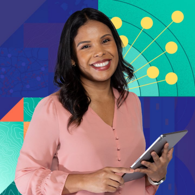 A woman in a light pink blouse holds a digital tablet in front of a colorful abstract background. 