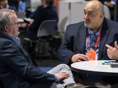 Two people having a discussion in a booth at the Expo