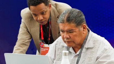 Esri expert assists a user whoe is seated in front of an open laptop