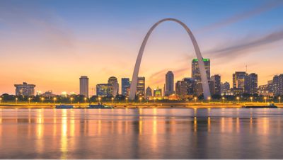 The Gateway Arch in St. Louis, Missouri, seen from across the Mississippi River at dusk
