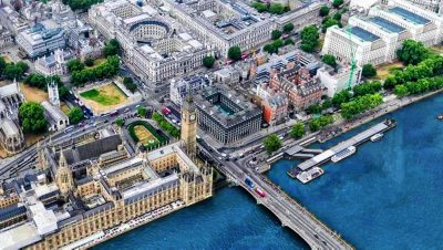 A digital twin of an aerial view of London, England, showing the River Thames, Houses of Parliament, and Big Ben.