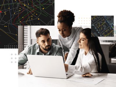  Team collaborating around a laptop with geospatial maps and location data overlays, illustrating data-driven strategy and spatial analysis