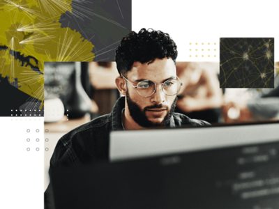 Person working at a computer with abstract map networks and spatial data overlays representing geospatial strategy and location intelligence