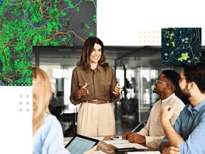  Team collaborating in a meeting with digital maps and geospatial data visuals in the background